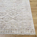 Close-up of the Cadell Area Rug showing its beige, ivory, and sandstone traditional pattern and soft texture. Front