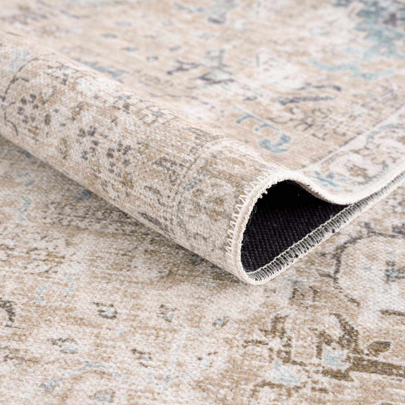 Close-up of the Beige Holi-4600 Washable Area Rug, showing its traditional vintage pattern and soft, neutral cream and brown colors. Fold