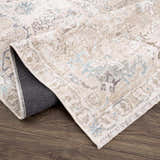 Close-up of the Beige Holi-4600 Washable Area Rug showing its cream, brown, and peach traditional vintage pattern and fringed edge. Fold