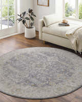 Light-filled sunroom with a round Dalupirip rug in gray, beige, and brown, styled with a daybed and potted plant. Roomscene-Round