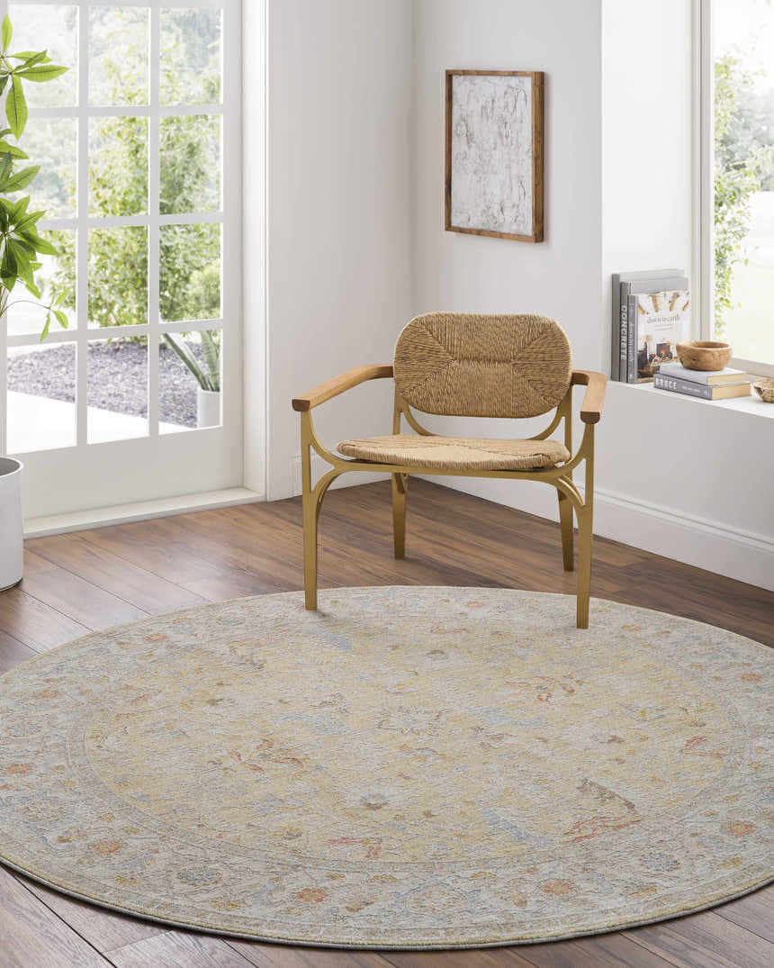 Light-filled room featuring a round Dario Thick Luxe Area Rug in amber and gray under a woven chair. Roomscene-Round