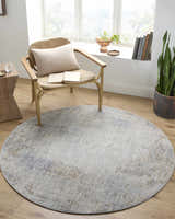 Cozy reading nook with round Deka Deep Teal Luxe Rug, woven chair, wood floors, and natural light. Roomscene-Round