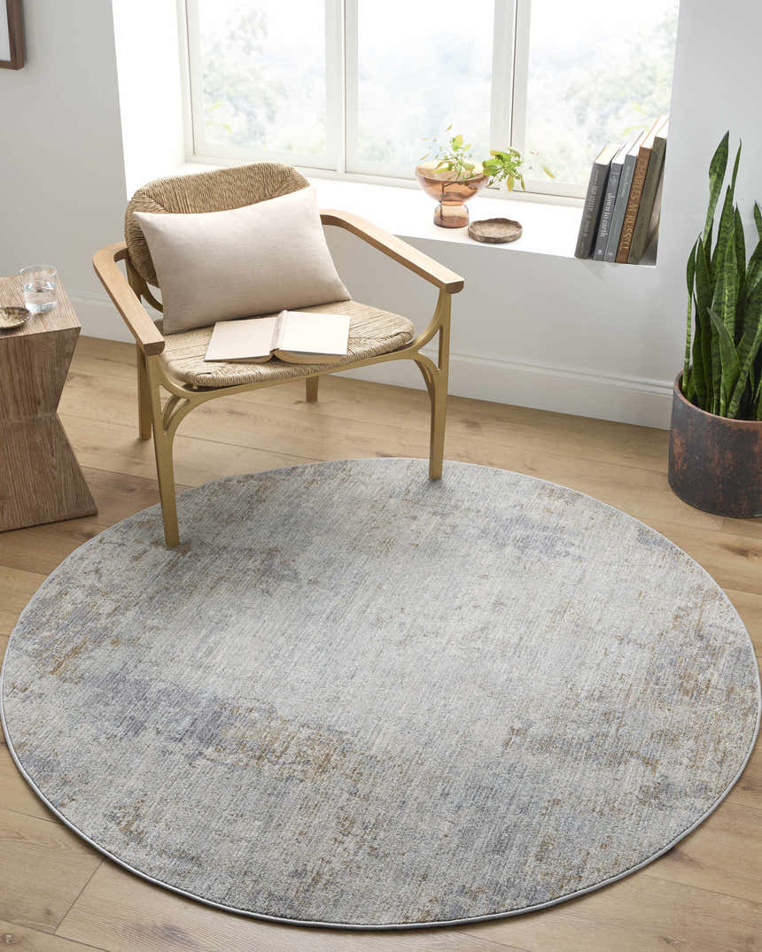 Cozy reading nook with round Deka Deep Teal Luxe Rug, woven chair, wood floors, and natural light. Roomscene-Round