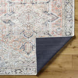 Close-up of the Aethwy Washable Area Rug showing its farmhouse style, light silver, prairie dust, and silver gray colors. Fold