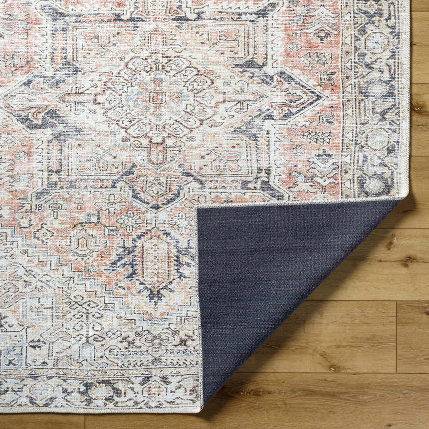 Close-up of the Aethwy Washable Area Rug showing its farmhouse style, light silver, prairie dust, and silver gray colors. Fold