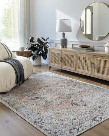 Living room scene with a light silver Aethwy Washable Area Rug, cream sofa, wooden cabinet, round mirror, and warm, inviting mood. Roomscene-Rectangle