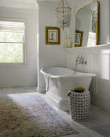 Farmhouse bathroom with white tub and Aethwy Washable Area Rug in light silver, prairie dust, and slate blue. Roomscene-Rectangle