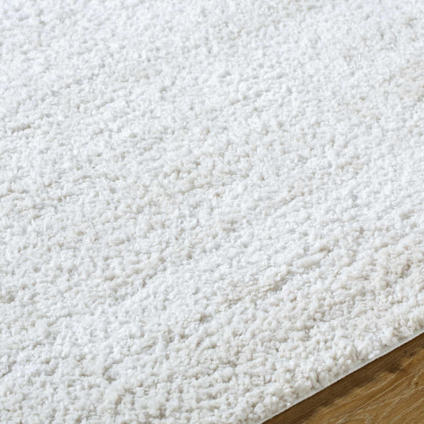 Close up of the plush, white shag texture of the Arlind Area Rug. Texture