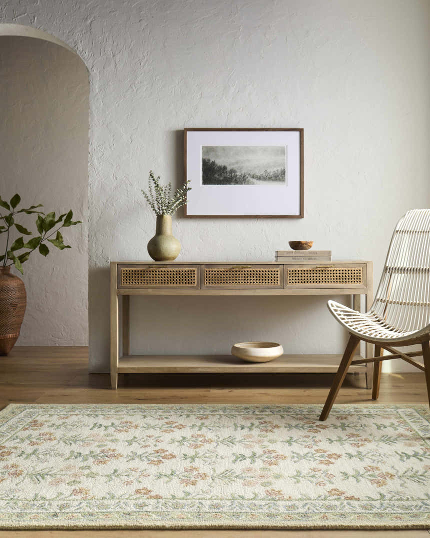 Neutral entryway with Alonsa Ivory rug, wood console table, woven chair, and textured white walls. Farmhouse style. Roomscene-Rectangle