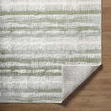 Close-up of the Asmara Green Area Rug, showcasing its ash, sage, and silver gray striped pattern and textured weave. Fold