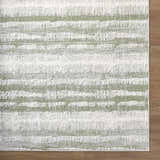 Close-up of the Asmara Green Area Rug, featuring a textured stripe pattern in sage, light silver, and silver gray. Corner