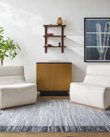 Living room scene with two chairs on a Dhaval Black Area Rug, cabinet, shelf, and cactus art. Roomscene-Rectangle