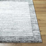 Close-up of the Dhaval Black Area Rug showing its charcoal, light gray colors, and soft, textured pile. Front