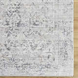 Close-up of the Alivia Area Rug. Charcoal, gray, and ivory traditional pattern on a machine woven polyester rug. Swatch