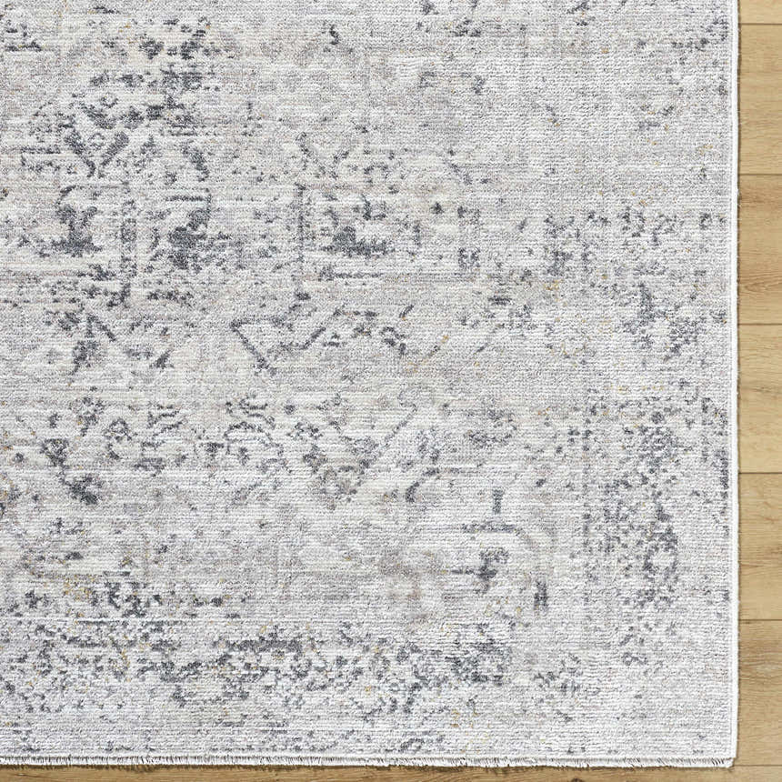 Close-up of the Alivia Area Rug. Charcoal, gray, and ivory traditional pattern on a machine woven polyester rug. Swatch