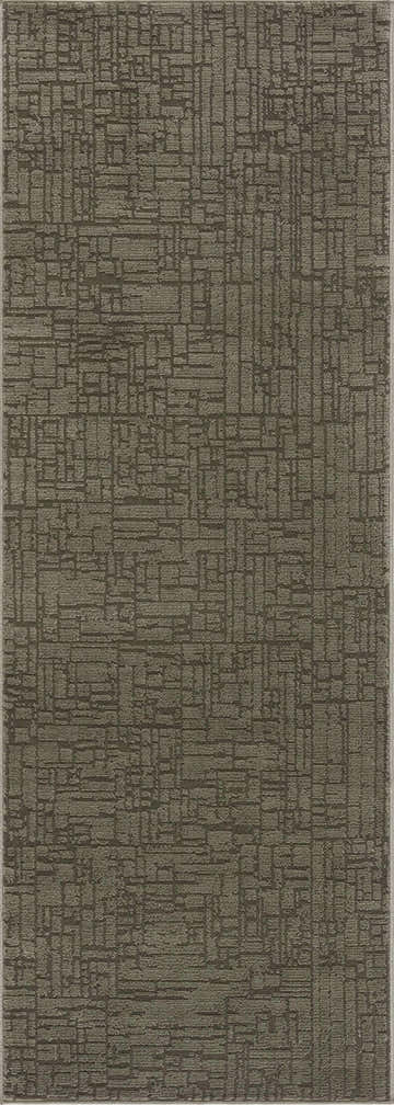 Close-up of the Leanna Green Washable Area Rug, showcasing its geometric pattern and textured gray-green color. Design-Runner