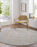 Sunlit room with a round Ehan Cream Thick Luxe Oushak Rug under a woven chair on wood floors. Roomscene-Round