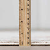 Close-up of the thick pile height of the Elimbah Luxe Area Rug with a ruler for scale. Pile
