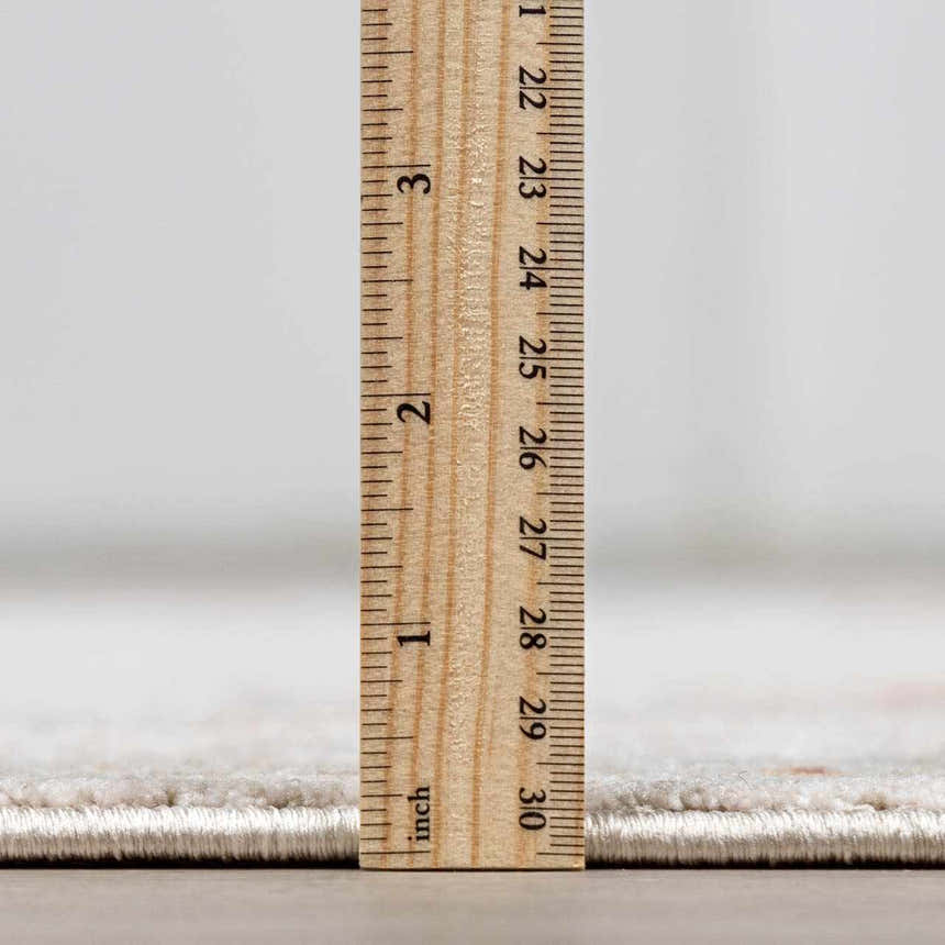 Close-up of the thick pile height of the Elimbah Luxe Area Rug with a ruler for scale. Pile