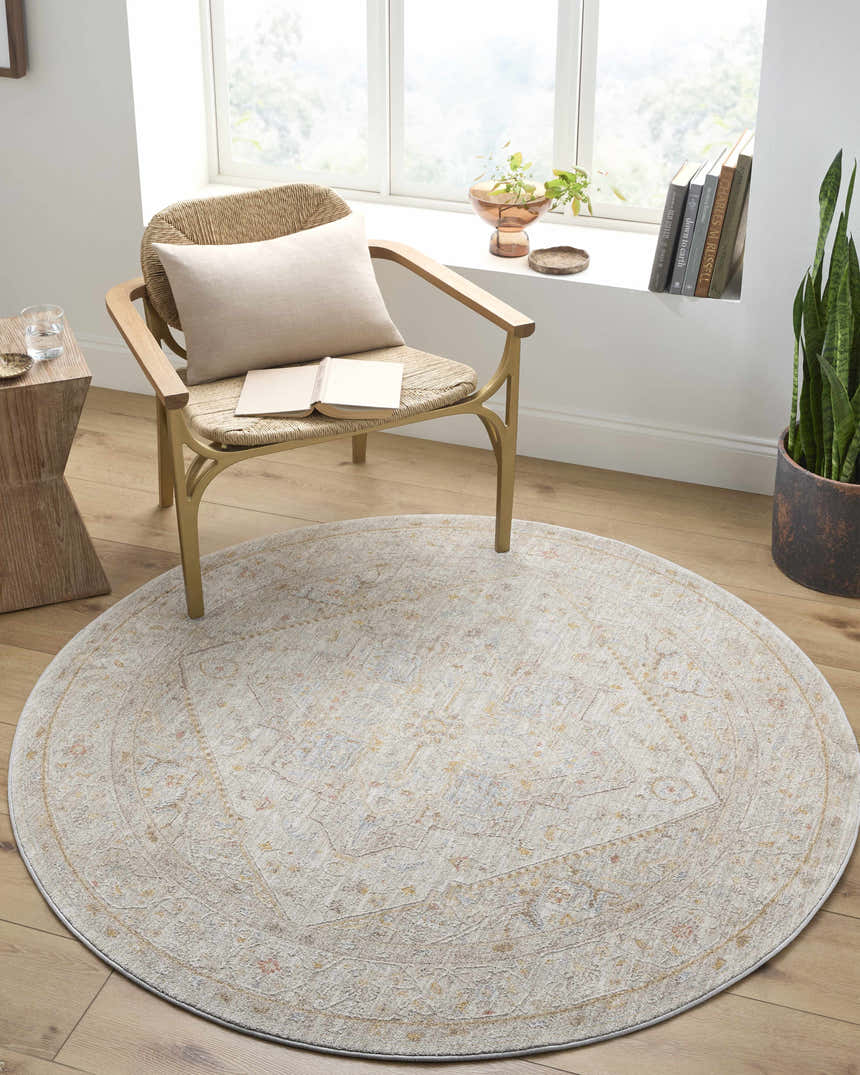 Sunlit reading nook with a round Engin Thick Luxe Area Rug, woven chair, side table, and potted plant. Roomscene-Round