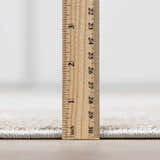 Close up of the Engin Thick Luxe Area Rug pile height with a ruler. Pile