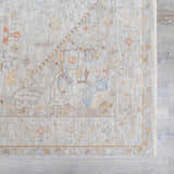 Close-up of the Engin Thick Luxe Area Rug. Features a traditional pattern in amber, dusty pink, and light olive tones. Swatch