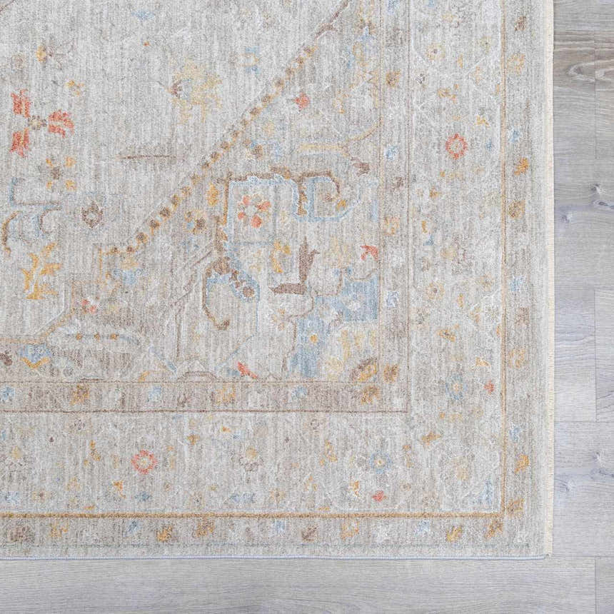 Close-up of the Engin Thick Luxe Area Rug. Features a traditional pattern in amber, dusty pink, and light olive tones. Swatch