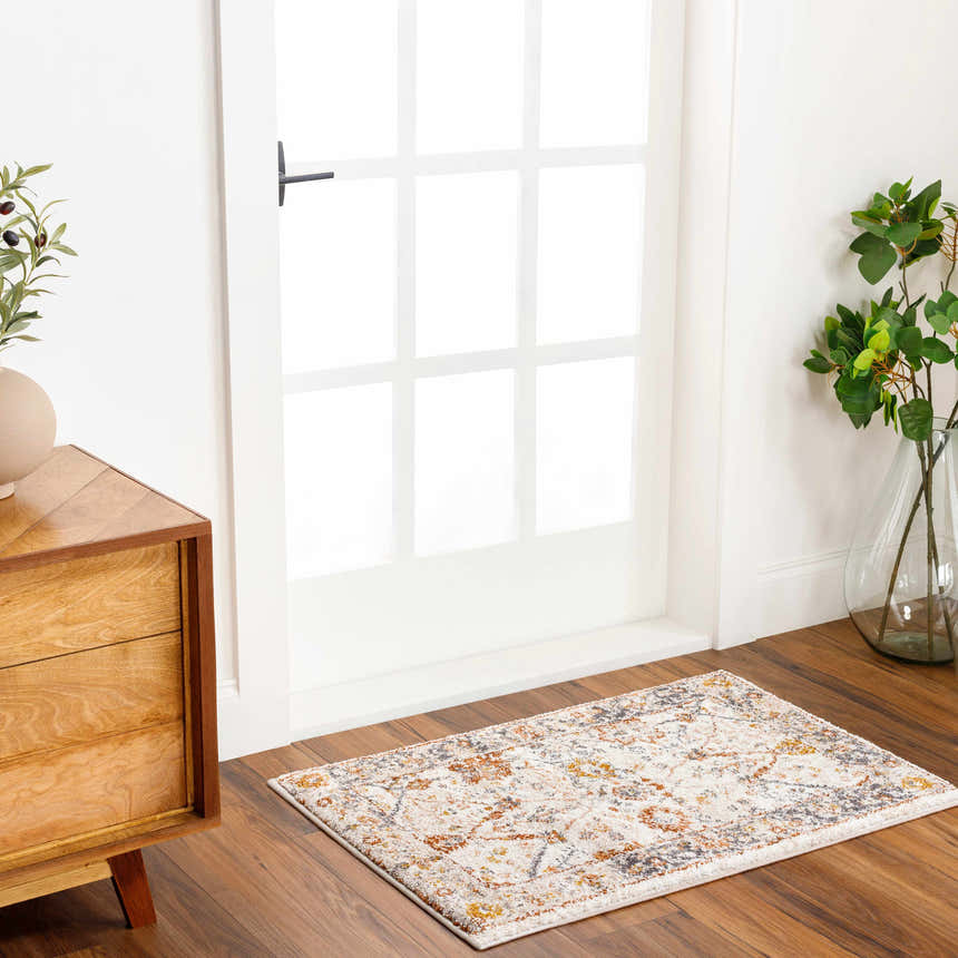 Entryway with wood floors and Paatan Luxe Floral Oushaq Area Rug, dresser, white door, and plants. Roomscene-Rectangle