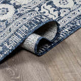 Close-up of the Etoile Navy Blue Performance Rug showing its traditional blue and white woven pattern and texture. Fold