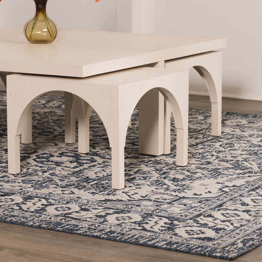 Close-up of the Etoile Navy Blue Performance Rug with a traditional pattern under a modern white coffee table. Roomscene-Rectangle
