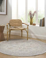 Sunlit reading nook with round Coby Sage Avant Garde rug, woven chair, wood accents, and soft, neutral hues. Roomscene-Round