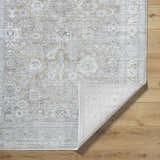 Close-up of the Alexia Light Gray Area Rug showing its traditional design, light gray, charcoal, and medium gray colors. Fold