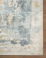 Close-up of the Alanna Thick Luxe Area Rug showing its beige, gray, and teal contemporary design and plush texture. Corner