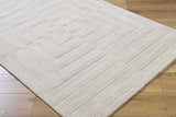 Close-up of the light silver Aretha Area Rug. Hand-loomed wool rug with a geometric pattern and subtle texture. Corner
