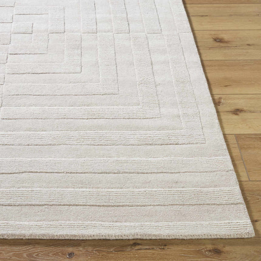 Close up of the light silver Aretha Area Rug showing the hand loomed geometric design and wool texture. Front