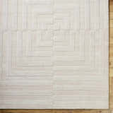 Close-up of the light silver Aretha Area Rug. Hand-loomed wool rug with a geometric square pattern and textured design. Swatch