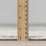 Close-up of the Fallin Gray Thick Luxe Abstract Striped Rug showing its plush pile height with a ruler for scale. Pile
