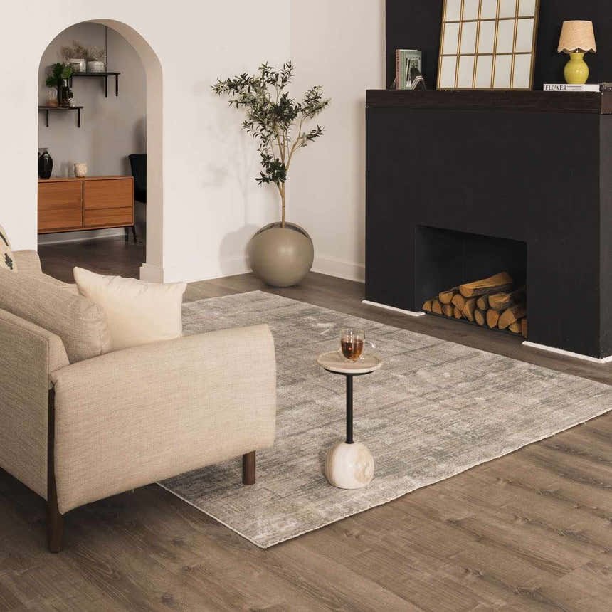 Living room scene with a Fallin Gray Thick Luxe Abstract Striped Rug, beige sofa, fireplace, and wood floors. Roomscene-Rectangle
