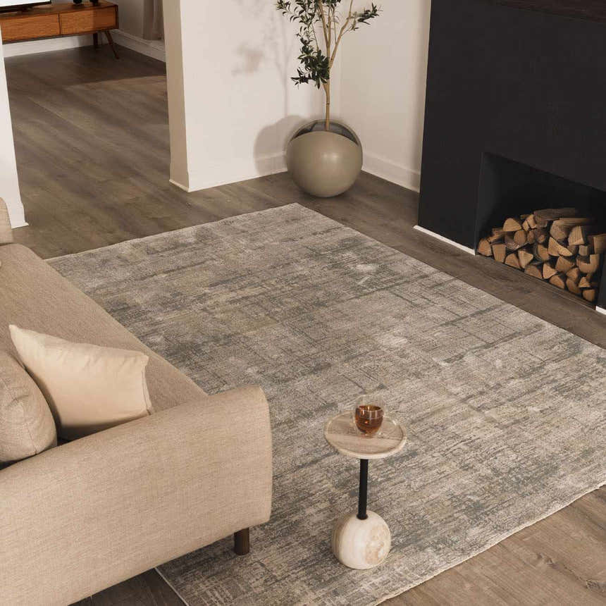 Living room scene with a Fallin Gray Thick Luxe Abstract Striped Rug, sofa, side table, and fireplace. Roomscene-Rectangle