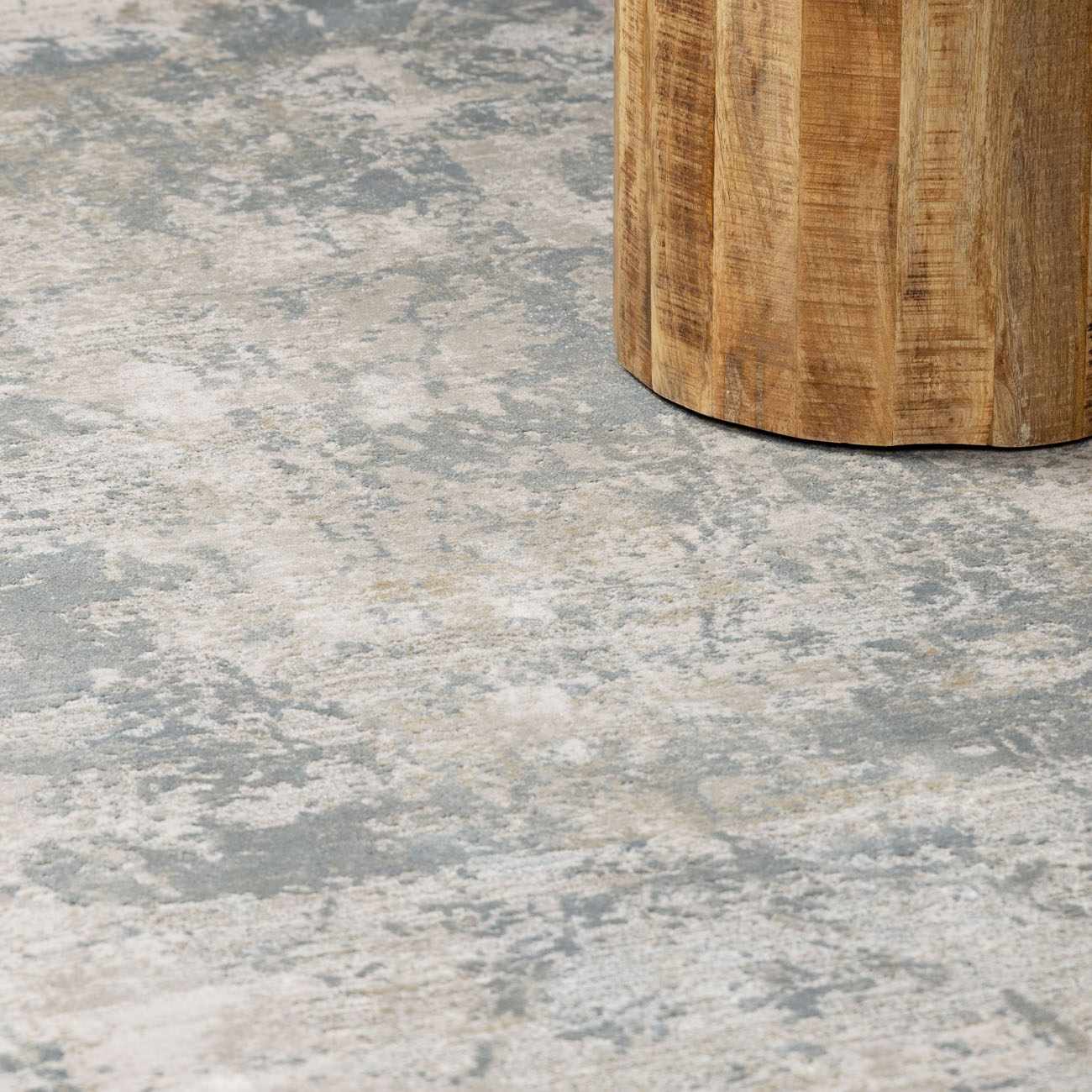 Close-up of the Fallin Gray Thick Luxe Abstract Striped Rug showing its gray, taupe, and white abstract pattern. Styleshot
