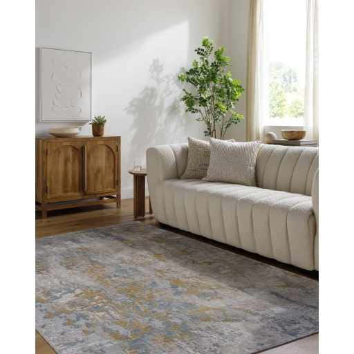 Living room scene with a beige sofa and the gray, beige Follansbee Area Rug. Roomscene-Rectangle
