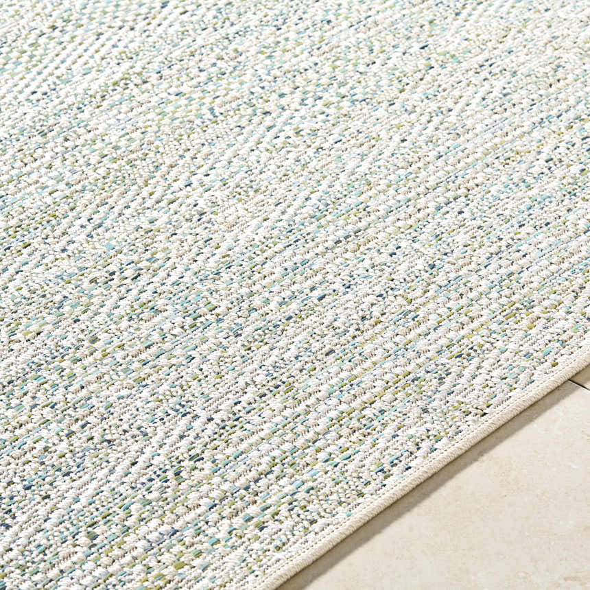Close-up of the Alezae Ivory Area Rug. Woven texture in ivory, light gray, and pale blue. Farmhouse style. Texture