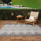 Outdoor poolside patio with a Frankville Black&White rug, chair, and small table. Roomscene-Rectangle