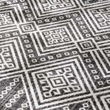 Close-up of the Frankville Black&White All Over Performance Rug, showing a geometric pattern and woven texture. Texture
