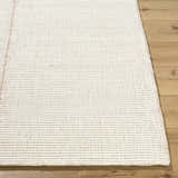Close up of the hand woven texture of the Xowi Global wool rug. Cream color. Front