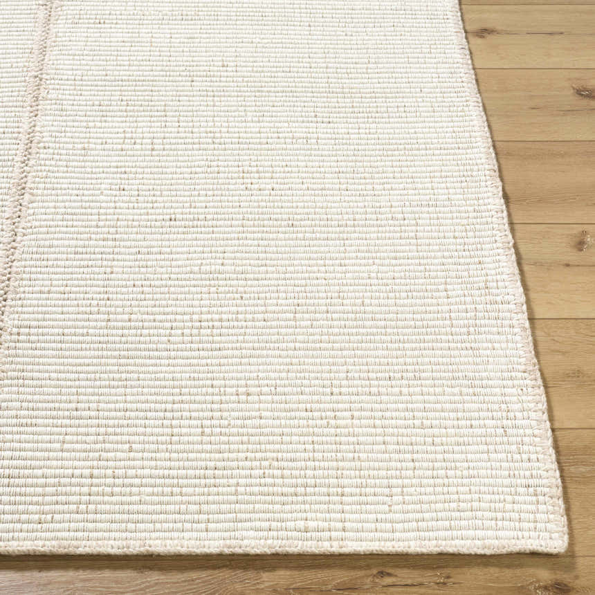 Close up of the hand woven texture of the Xowi Global wool rug. Cream color. Front