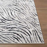 Close-up of the Arlene Area Rug featuring a contemporary black, cream, and gray abstract striped design. Front