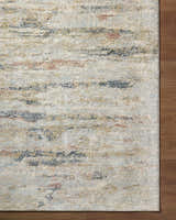 Close-up of the Attila Thick Luxe Area Rug showing beige, pink, gray, and teal horizontal striations. Corner
