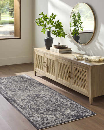 Entryway with Alissa Black Area Rug, wood floors, and a console table with a round mirror. Roomscene-Runner