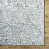 Close-up of the Genkei Black Area Rug showing its charcoal and light gray abstract pattern and soft texture. Corner